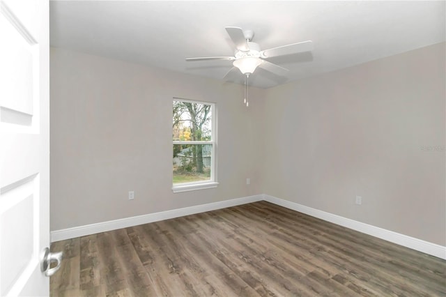 unfurnished room with ceiling fan and dark hardwood / wood-style floors