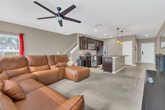 living room with ceiling fan and sink