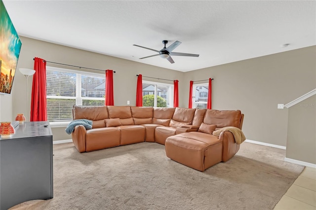 living room with ceiling fan, plenty of natural light, and light carpet