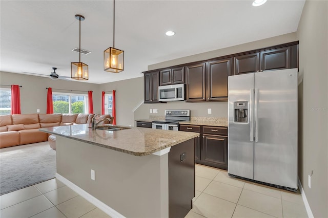 kitchen featuring dark brown cabinetry, ceiling fan, sink, hanging light fixtures, and stainless steel appliances