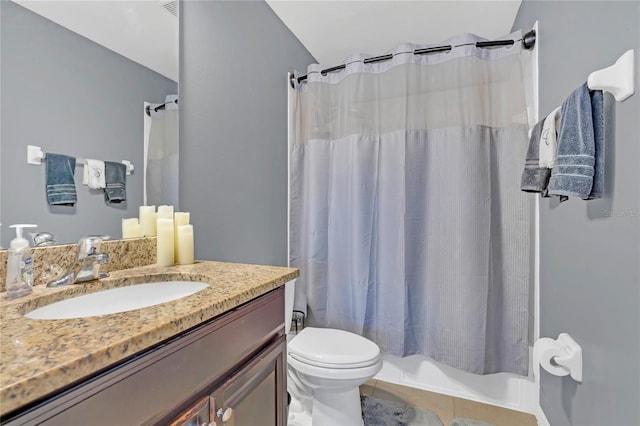 bathroom featuring vanity, lofted ceiling, and toilet