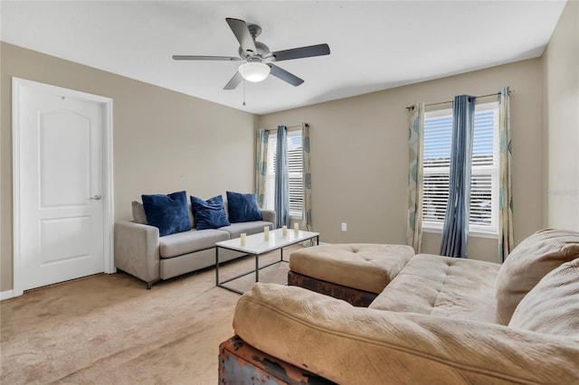 carpeted living room with ceiling fan