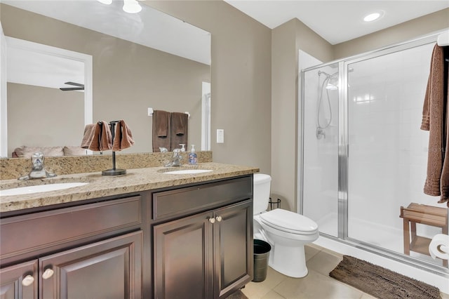 bathroom with tile patterned flooring, vanity, an enclosed shower, and toilet