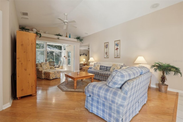 living room with ceiling fan, wood-type flooring, and vaulted ceiling