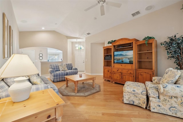 living room with ceiling fan, light hardwood / wood-style flooring, and vaulted ceiling