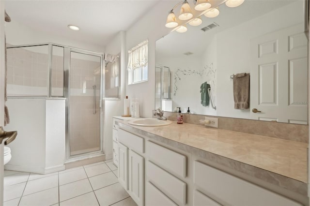 bathroom with vanity, an inviting chandelier, tile patterned flooring, toilet, and a shower with shower door