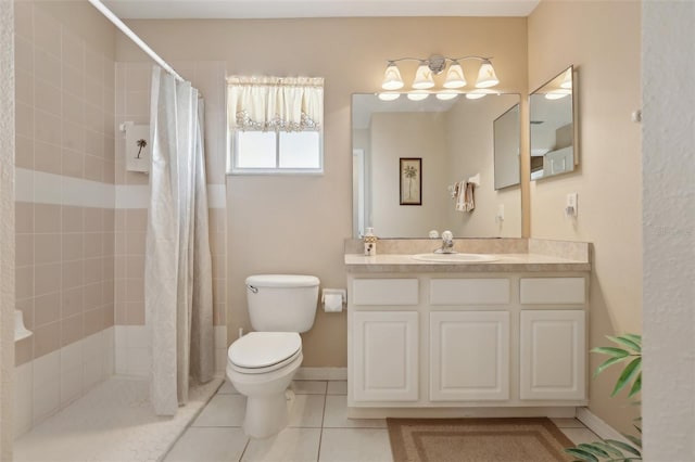 bathroom with tile patterned floors, toilet, vanity, and walk in shower