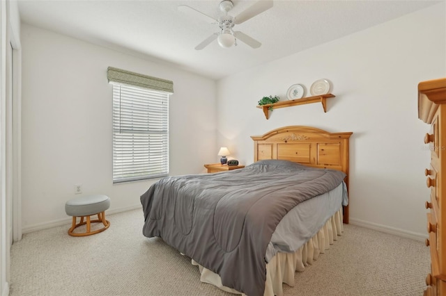 bedroom featuring ceiling fan and light colored carpet