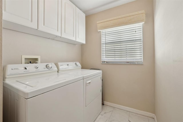 laundry area featuring washer and clothes dryer and cabinets