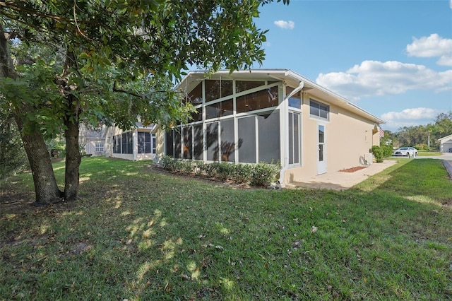 back of property with a lawn and a sunroom