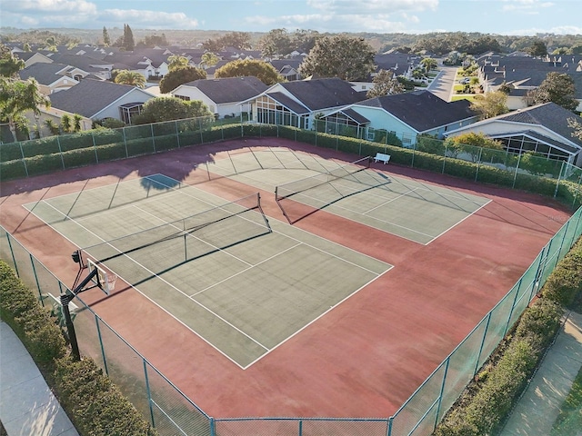 view of tennis court with basketball hoop