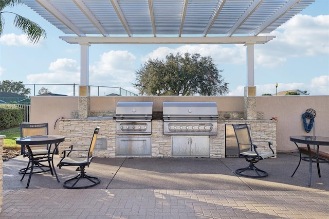 view of patio / terrace with an outdoor kitchen, area for grilling, and a pergola