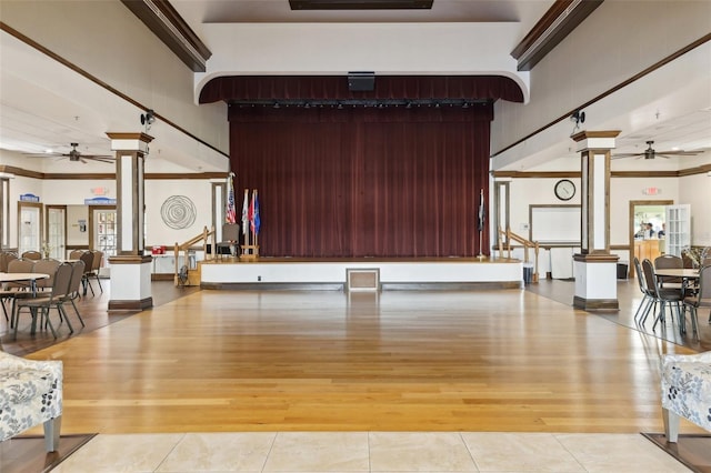 welcome area featuring ornate columns and ceiling fan