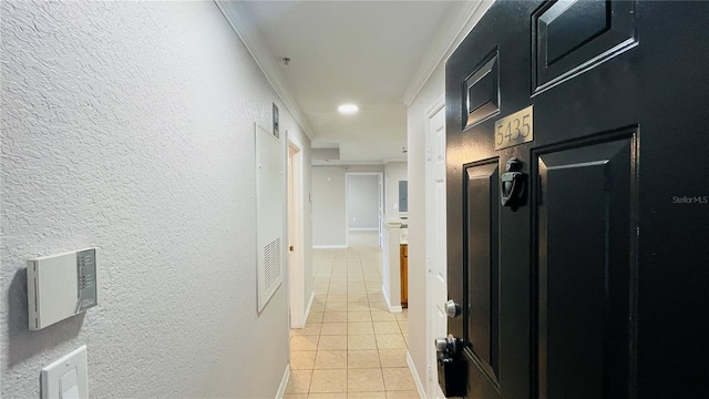 corridor featuring light tile patterned flooring and crown molding