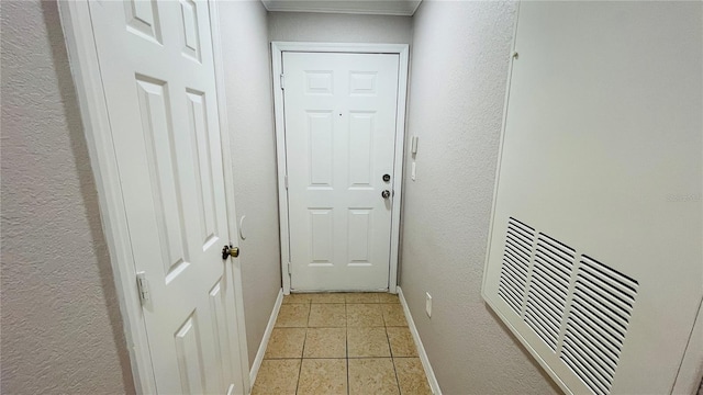 doorway to outside with light tile patterned flooring