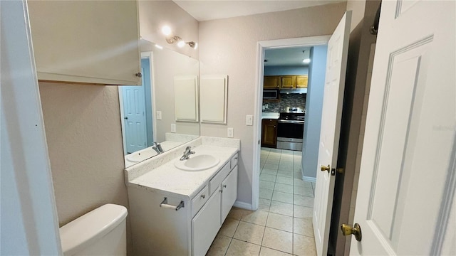 bathroom featuring decorative backsplash, tile patterned flooring, vanity, and toilet