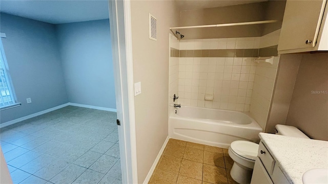 full bathroom featuring tile patterned floors, vanity, toilet, and tiled shower / bath