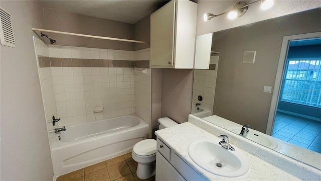 full bathroom with tile patterned floors, vanity, tub / shower combination, and toilet