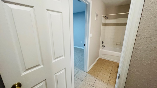 bathroom featuring tile patterned floors and tiled shower / bath