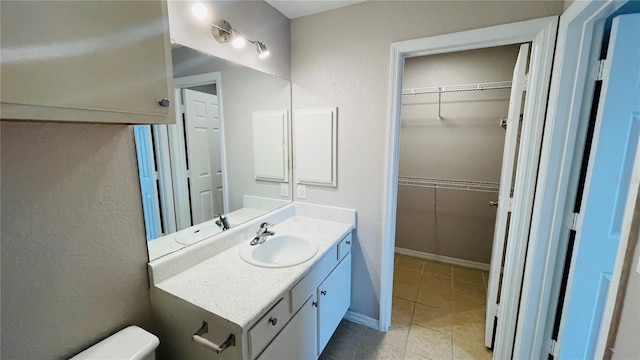 bathroom featuring tile patterned floors, vanity, and toilet