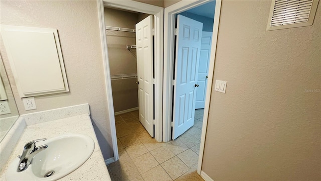 bathroom featuring tile patterned flooring and vanity