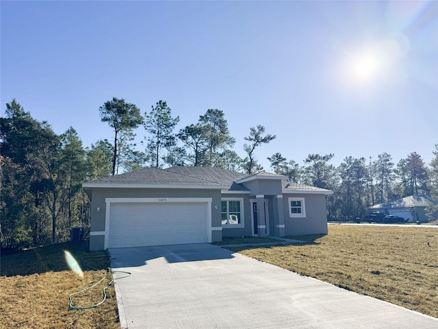 view of front facade with a front yard and a garage