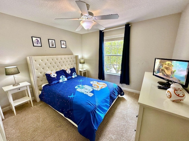 carpeted bedroom with ceiling fan and a textured ceiling