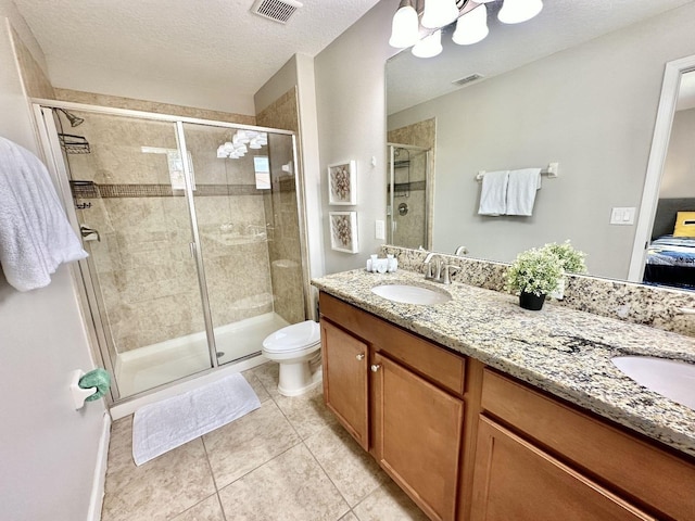 bathroom with tile patterned flooring, an enclosed shower, and vanity