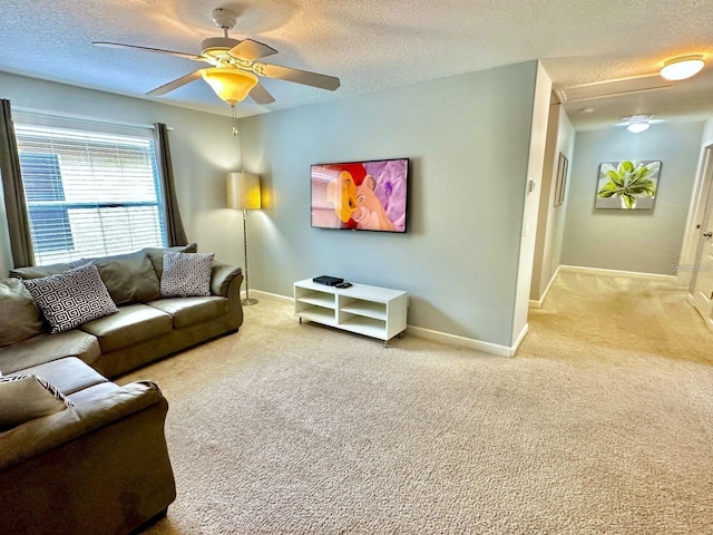 living room featuring a textured ceiling, ceiling fan, and light carpet