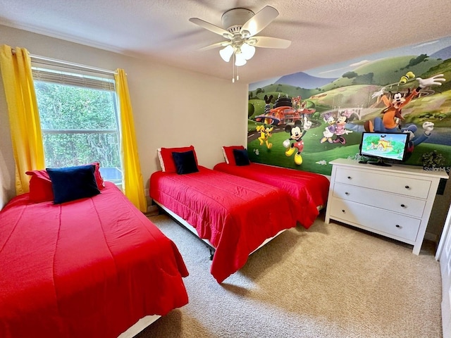 bedroom with a textured ceiling, ceiling fan, and carpet flooring