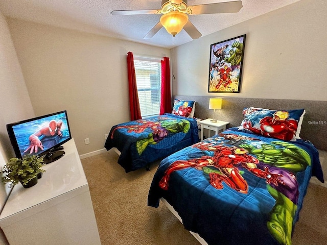 carpeted bedroom featuring ceiling fan and a textured ceiling