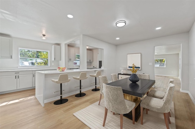 dining room featuring light wood-type flooring and plenty of natural light