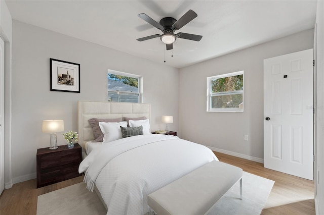 bedroom featuring light wood-type flooring and ceiling fan