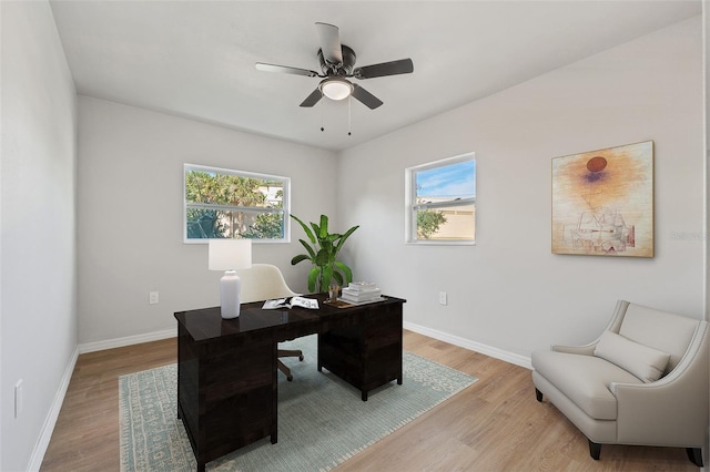 office with ceiling fan and light hardwood / wood-style floors