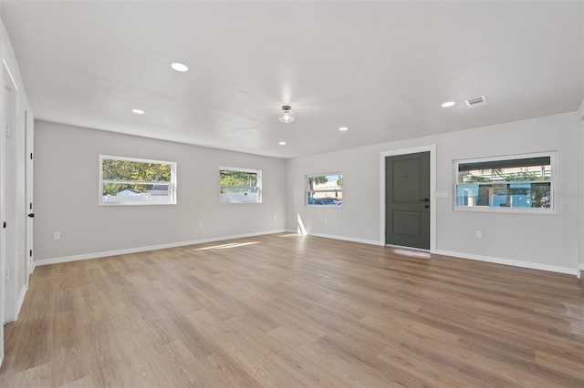 unfurnished living room with light hardwood / wood-style flooring