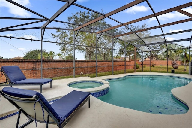 view of swimming pool with a lanai, an in ground hot tub, and a patio