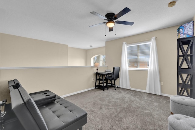 living area with carpet floors and ceiling fan