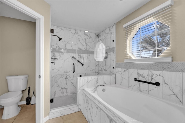 bathroom with tile patterned flooring, toilet, and shower with separate bathtub