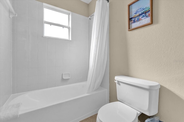 bathroom with shower / bath combo and toilet