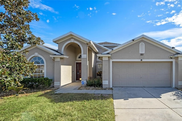 view of front of house with a garage and a front yard