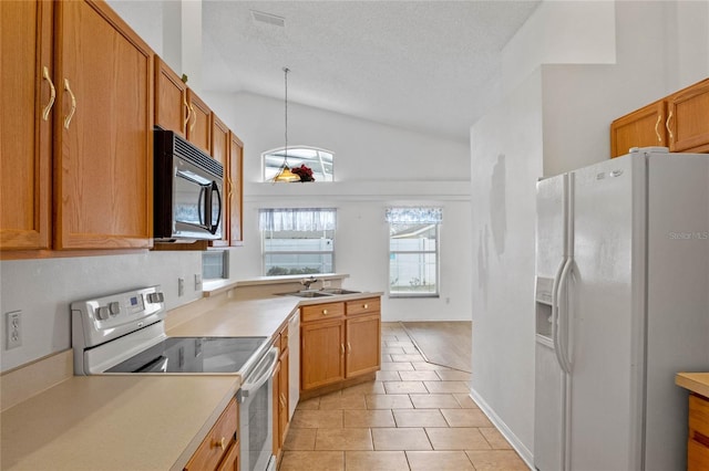 kitchen with light tile patterned floors, white appliances, lofted ceiling, hanging light fixtures, and sink