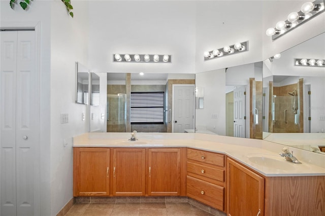 bathroom featuring a shower with door and vanity