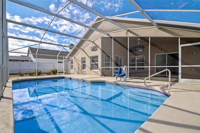 view of pool with a patio and glass enclosure