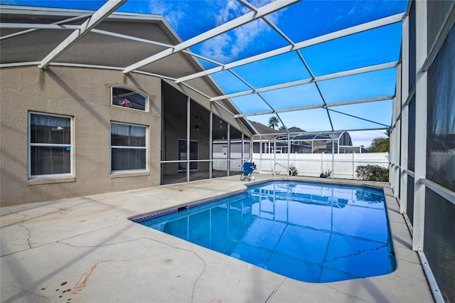 view of swimming pool with a patio area and a lanai