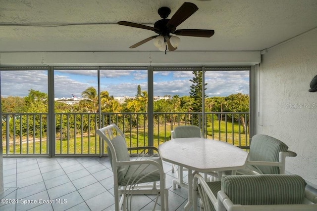 sunroom / solarium featuring ceiling fan