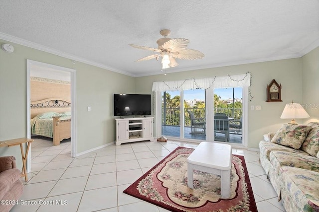 tiled living room with ceiling fan, ornamental molding, and a textured ceiling