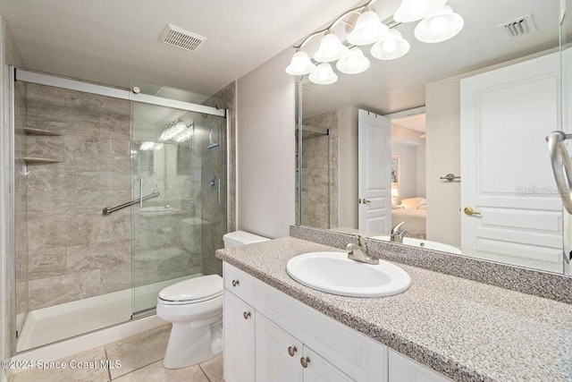 bathroom featuring tile patterned floors, vanity, toilet, and an enclosed shower