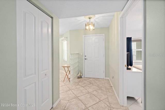 interior space with light tile patterned floors and a notable chandelier