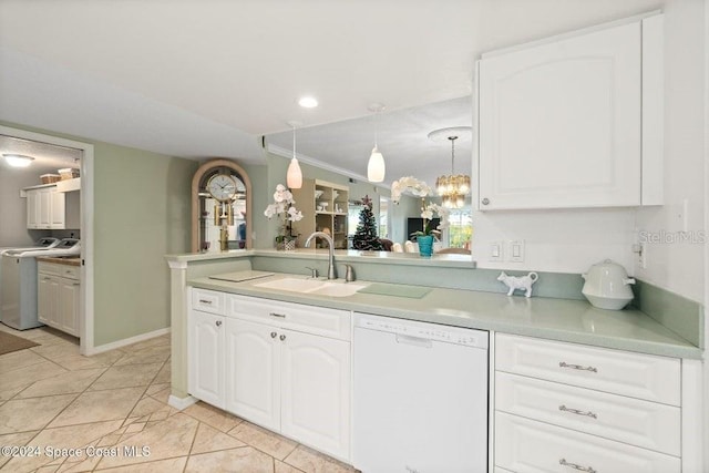 kitchen with pendant lighting, dishwasher, white cabinets, sink, and washer / clothes dryer