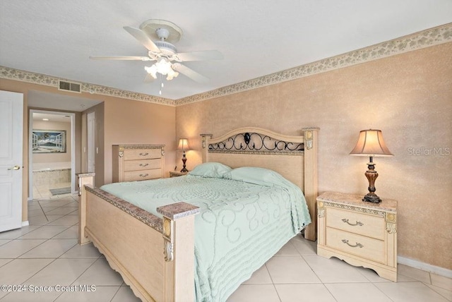 tiled bedroom with ceiling fan and ensuite bathroom